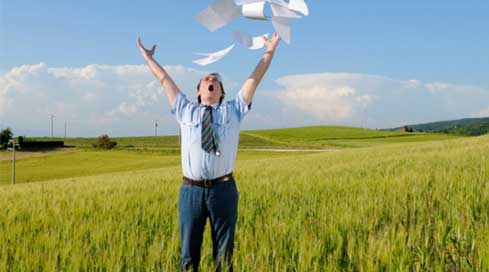 man celebrating his new document management system by throwing paper in the air