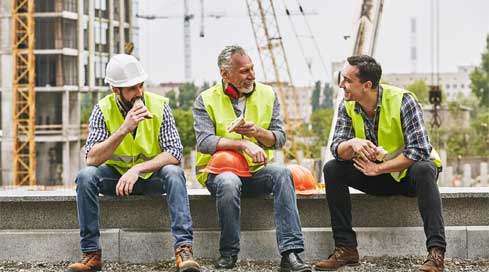 construction workers chatting on a construction site during their break